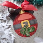 A christmas tag shaped like a Christmas bauble with the name Kyra on it