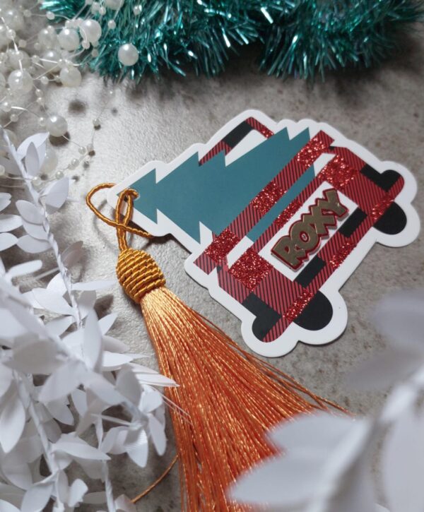 A farm fresh christmas tag with the picture of a tree in the back and the name Roxy on it.